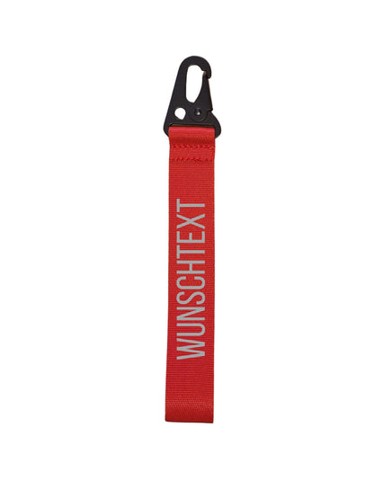 roter Schlüsselanhänger mit reflektierendem Text: Wunschtext