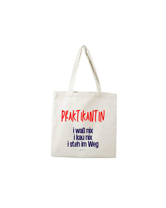Naturfarbene Biobaumwolltasche: roter Text: Praktikantin, blauer Text: i waß nix, i kau nix, i steh im Weg